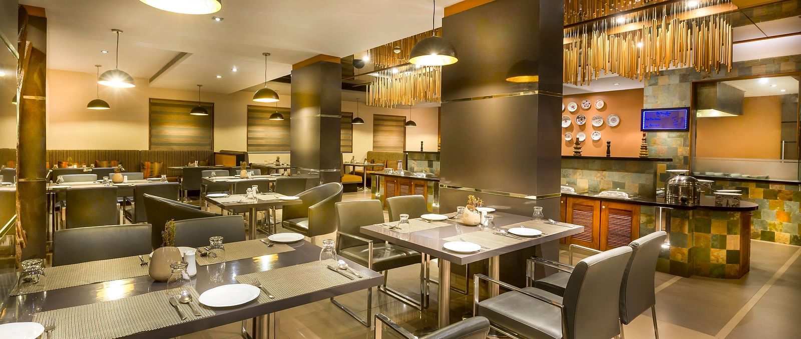  Modern restaurant interior with dark wood accents, leather chairs, and ambient lighting.