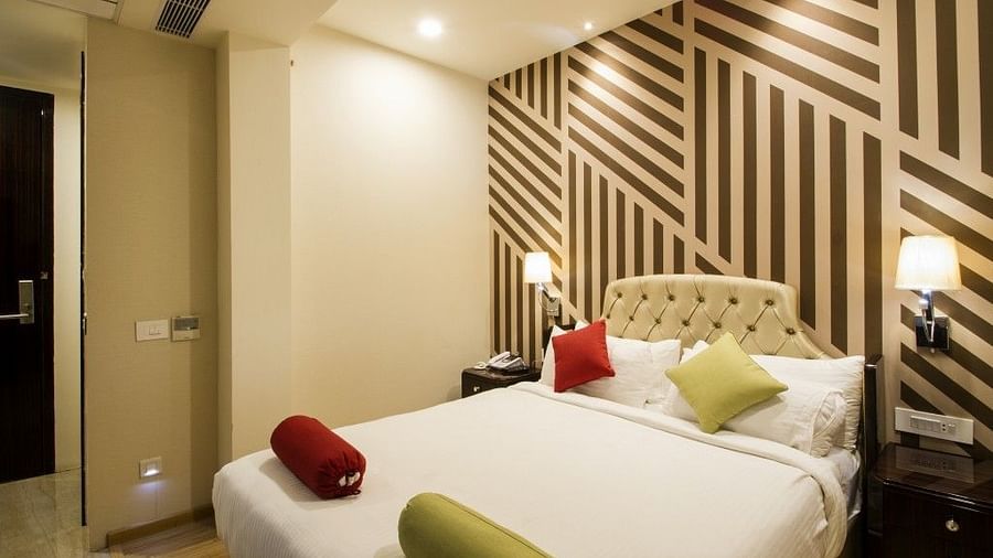 Standard room with bed and lamp on both the sides of the bed at Art Boutique Hotel, Hyderabad 