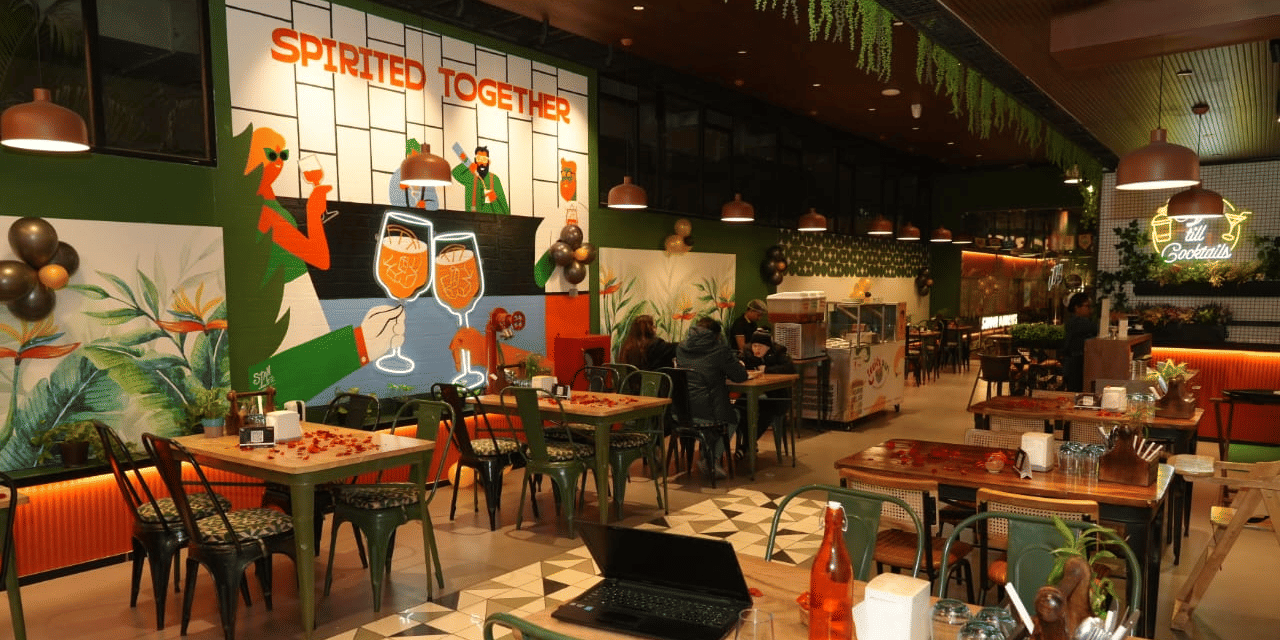 Art-inspired Effe Cafe at Papaya Tree Hotels featuring creative wall artwork, comfortable seating, and a lively dining atmosphere.