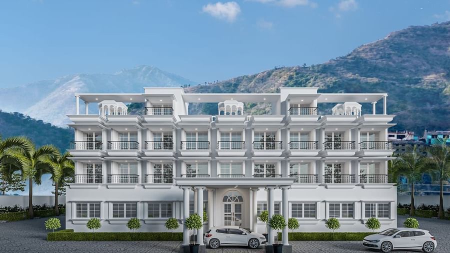 Front view shot of the facade of Namaste Corbett with beautiful mountains in the background.