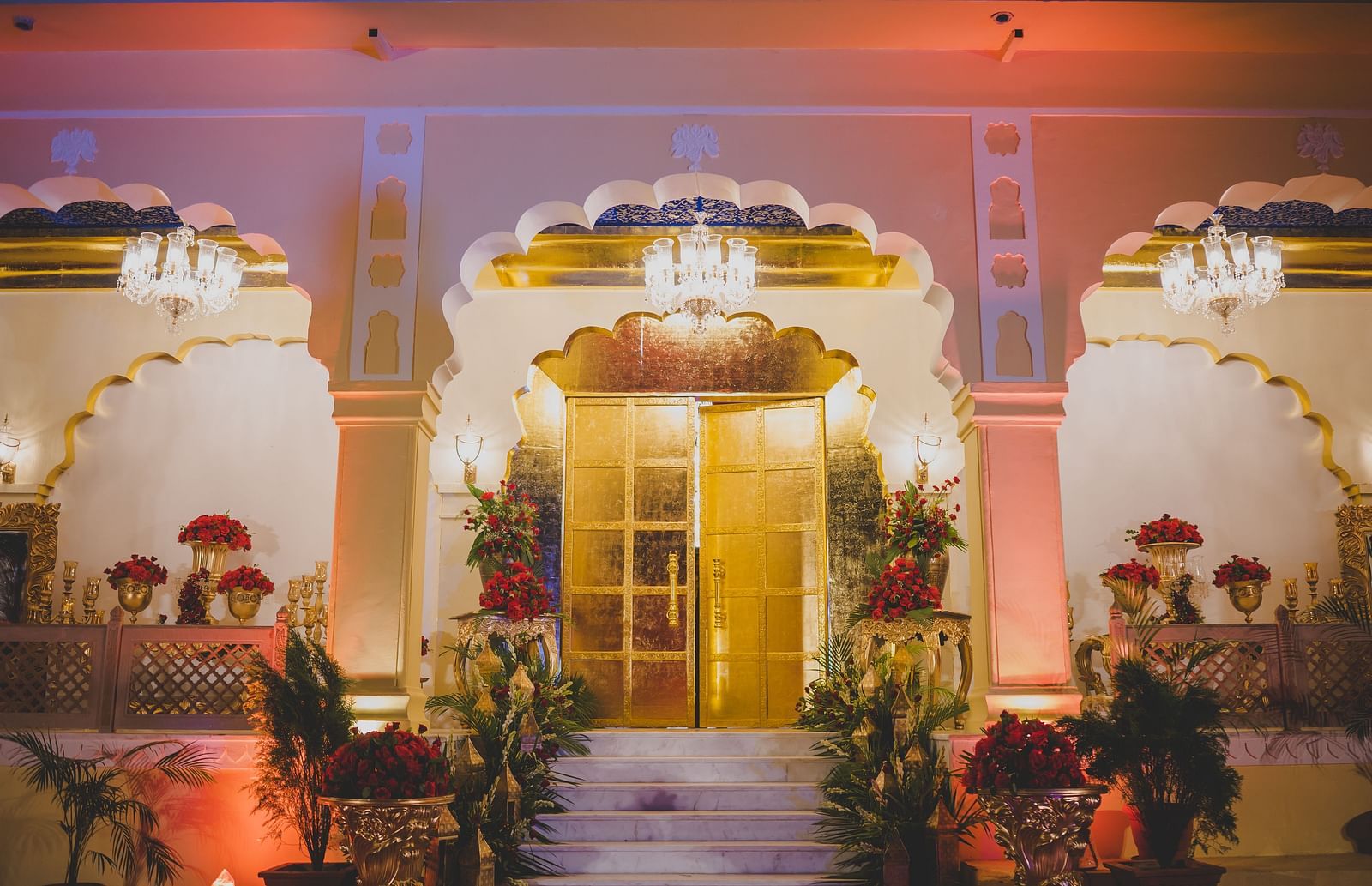 Image of the entrance of Swarn Mahal decorated with plants and flowers on the side at Rajasthali Resort & Spa Jaipur.