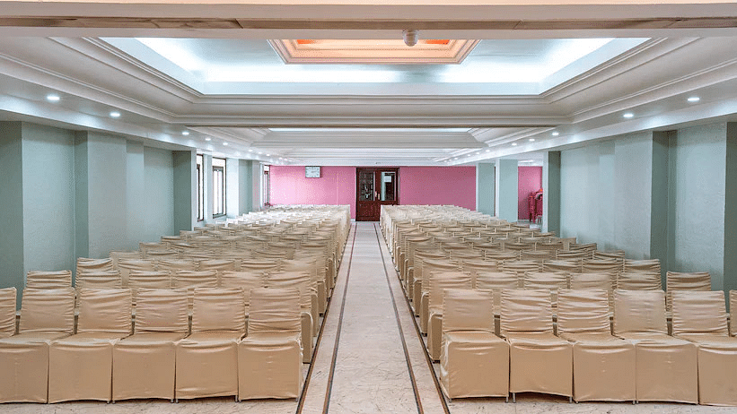 View of spacious Banquet Hall with  multiple chairs and modern interior - Hotel Ram International, Pondicherry
