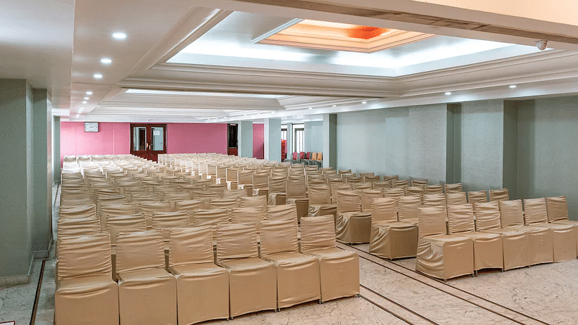 Side view of Banquet Hall with multiple chairs and modern interior - Hotel Ram International, Pondicherry