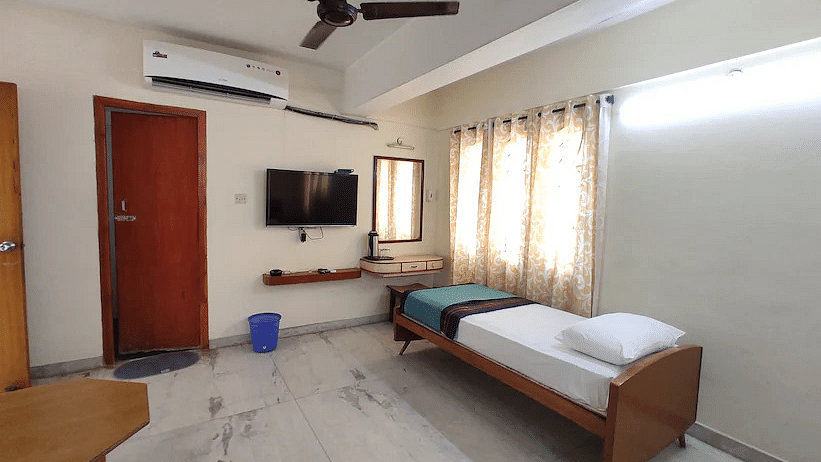 View of single bed in spacious Triple A/C room with basic amenities - Hotel Ram International,  Pondicherry