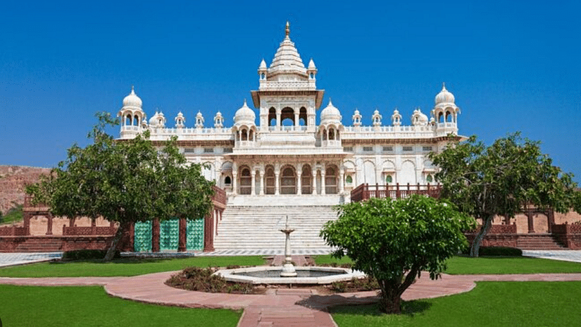 An exterior façade image of Jaswant Thada, highlighting its intricate marble architecture and beautiful design against a serene backdrop.