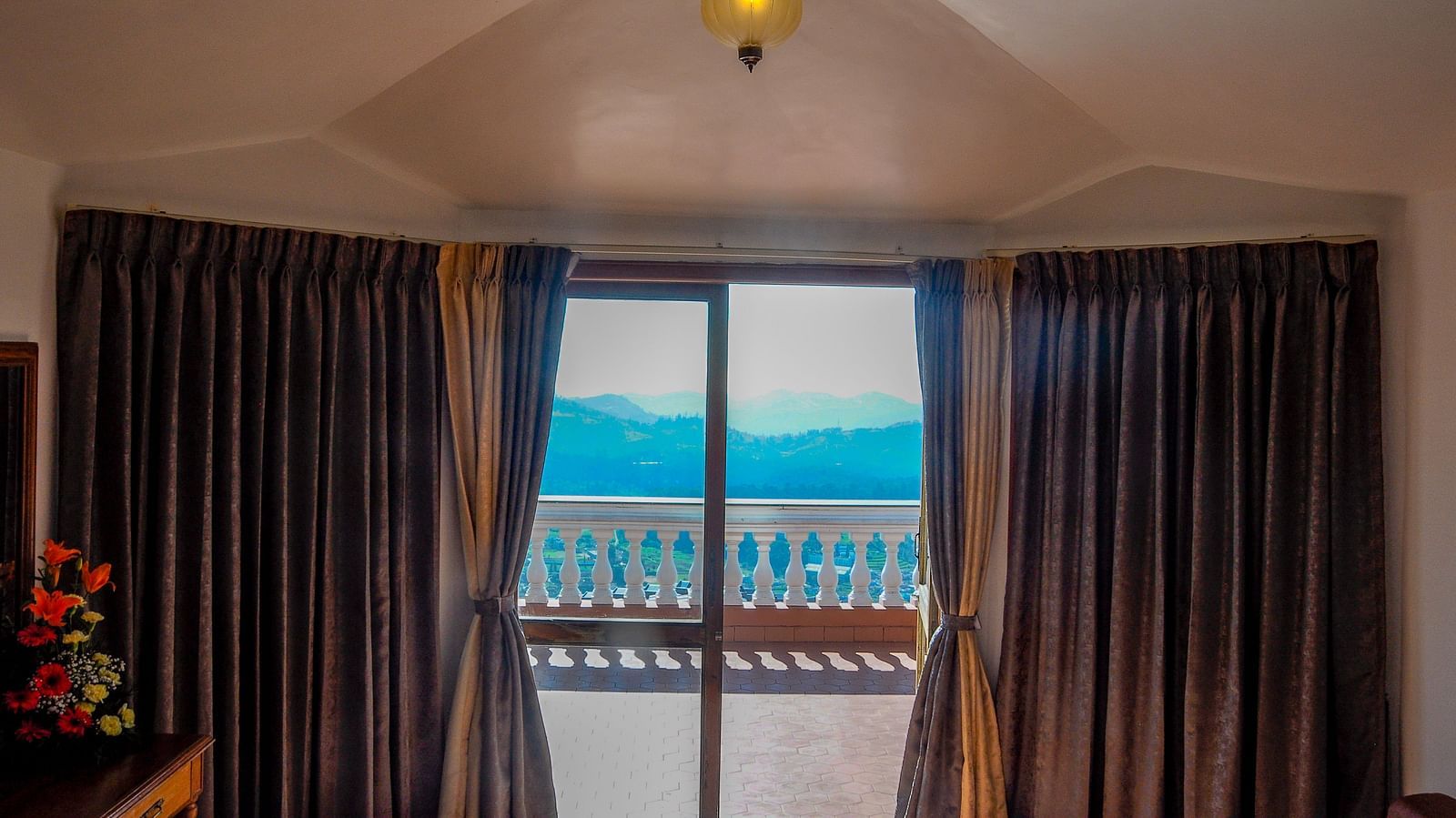 a view of the green valley of Ooty from the room at La Montana By TGI