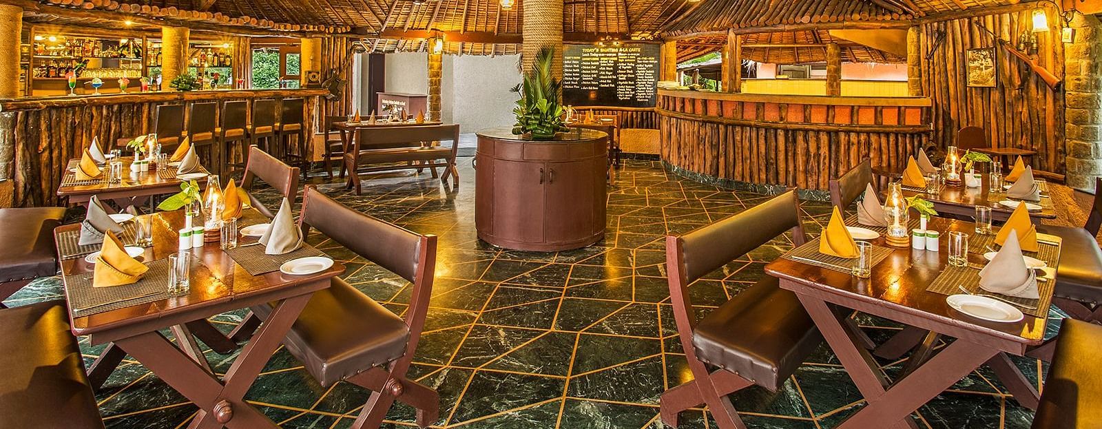 An image of a grill house with wooden interiors, wooden chairs and tables