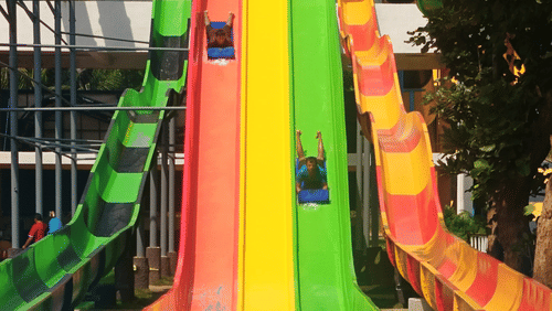 A vibrant, multicoloured water slide at Black Thunder Water Theme Park.