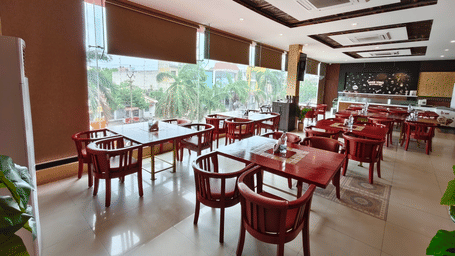 An interior view of a restaurant showing neatly placed dining tables, chairs, and window blinds at DSF Grand Plaza, Tuticorin.