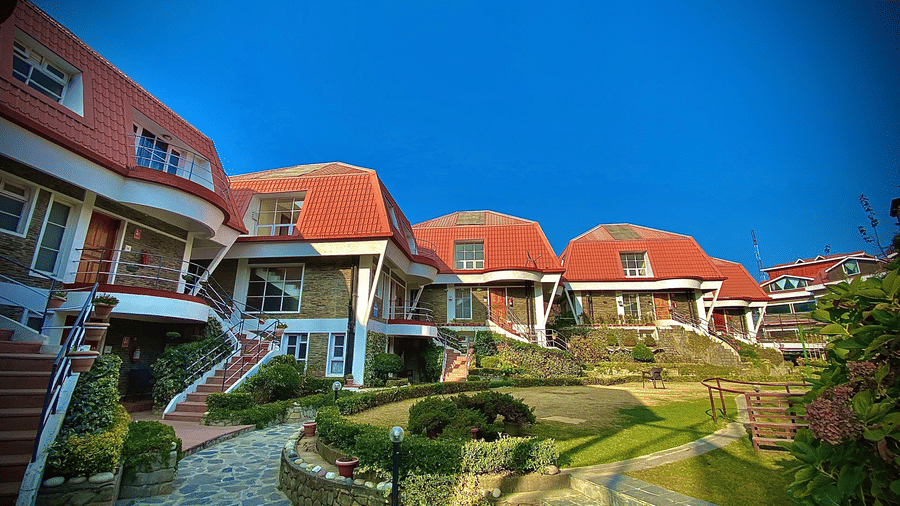 attic style cottages at Marigold Sarovar Portico, Mashobra Shimla. Each of these are three storey buildings with stairs and has a garden lawn at the centre.