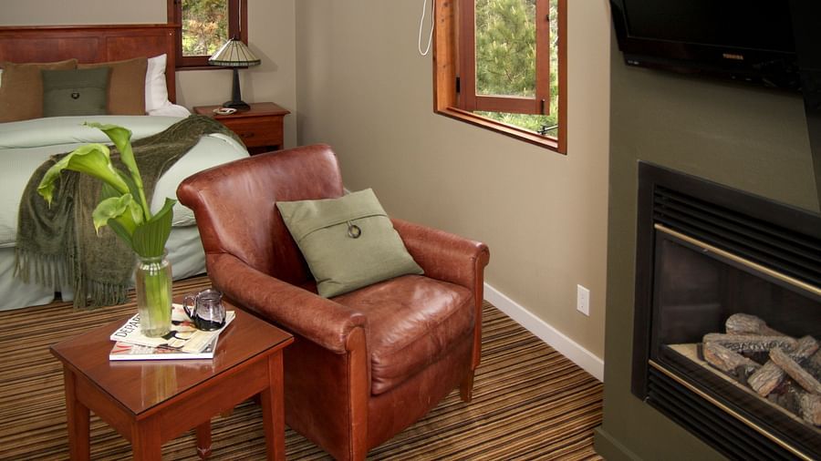 A cosy seating area by the fireplace with plush cushions - Brewery Gulch Inn & Spa