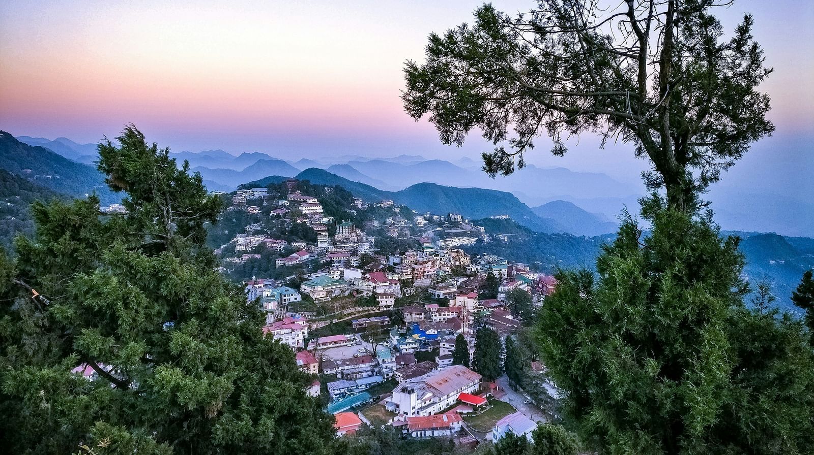 a bright facade image of a town from a hiltop