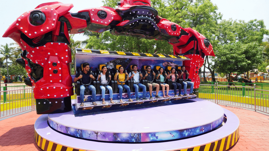 Visitors enjoy the Robo Cop ride at MGM Dizzee World Chennai, a futuristic thrill attraction with robotic arms, exciting spins, and high-energy movements for adventure seekers.