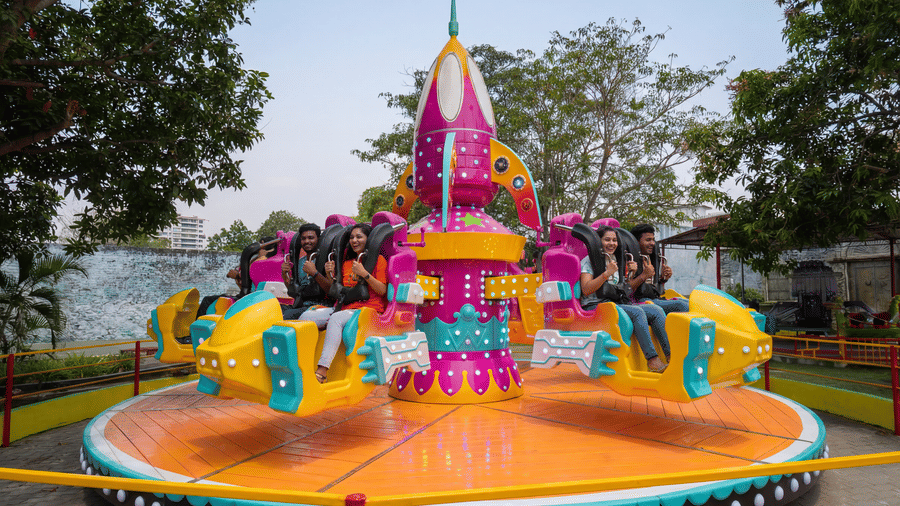 Guests ride the colourful Space Battle attraction at MGM Dizzee World Chennai, enjoying exciting spins, twists, and family-friendly thrills on a vibrant space-themed adventure.