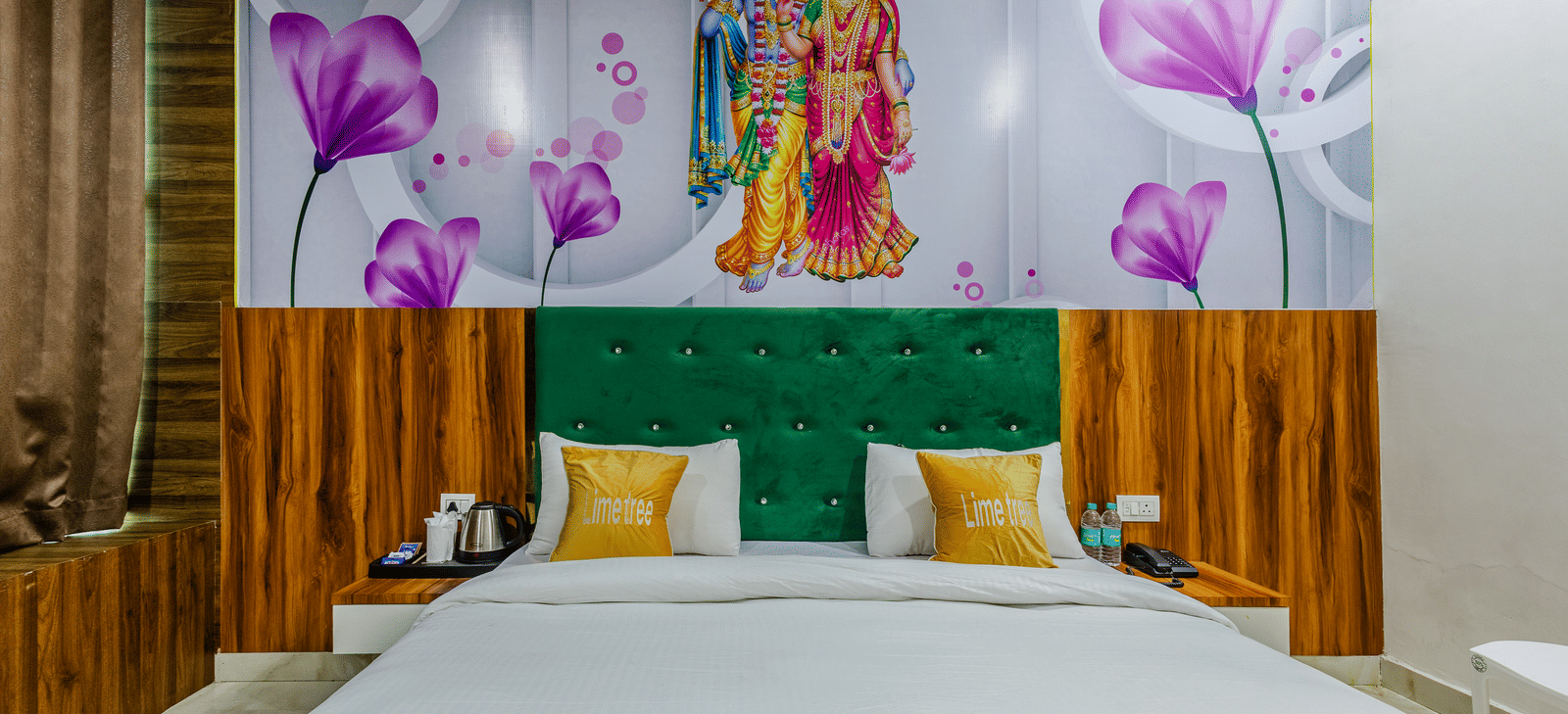 A bedroom with a green headboard, wooden panelling, and floral artwork above the bed - Lime Tree Hotels & Banquet, Vrindavan