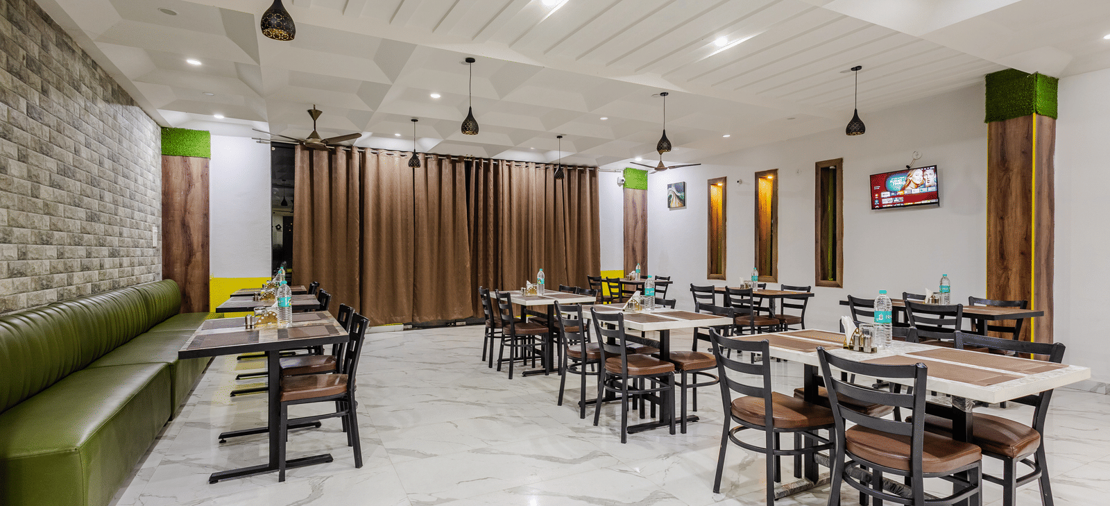The indoor restaurant at Lime Tree Hotels and Banquet, Vrindavan with well defined seating area.