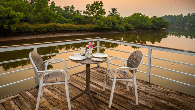 Evening Sunset at the outdoor seating area - Stone Wood Riverfront Resort, Siolim