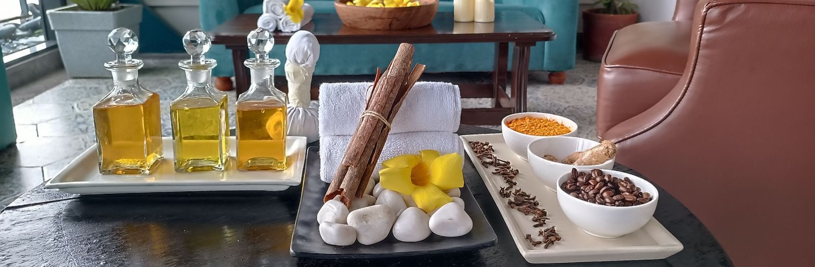 An indoor dining area at Polo Floatel Kolkata, featuring a long, dark wood table set with several small dishes.