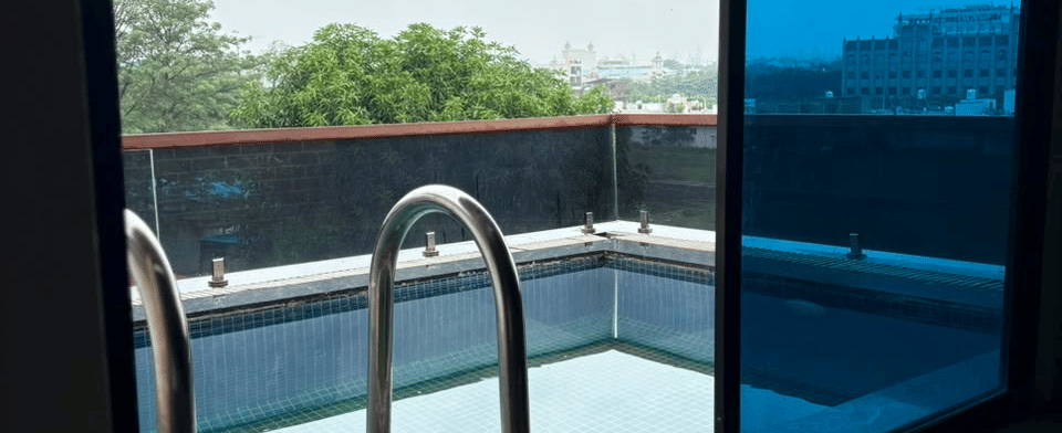 Emperor Room, The balcony infinity pool beyond the sliding glass doors