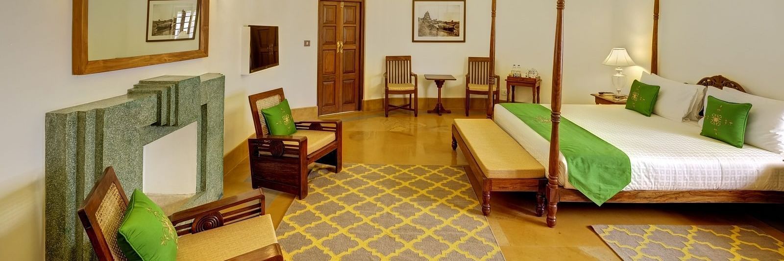 Heritage Suite with a double bed and a seating area at Saraca Hotel, Lucknow