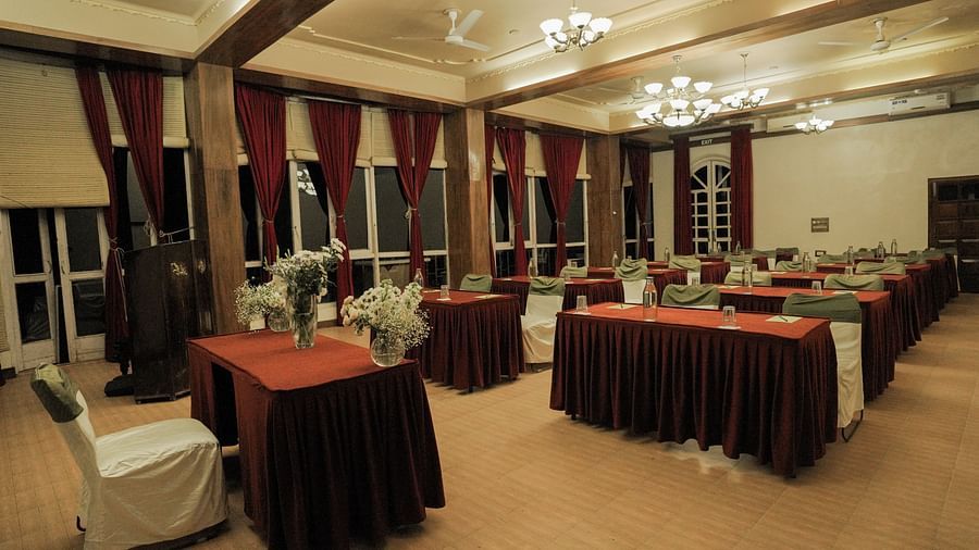 A dining room with tables and chairs, warm lighting, interior setting.