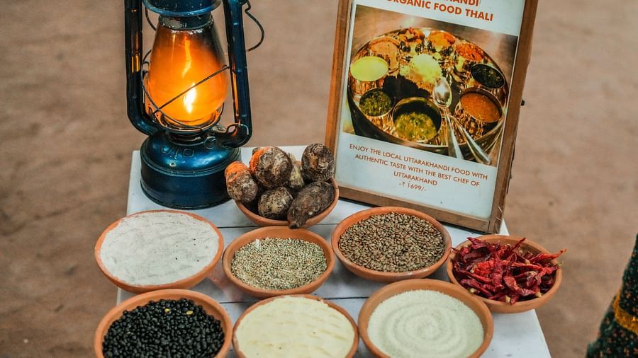 A table with bowls of ingredients, a lit lantern, and a framed picture, warm lighting.