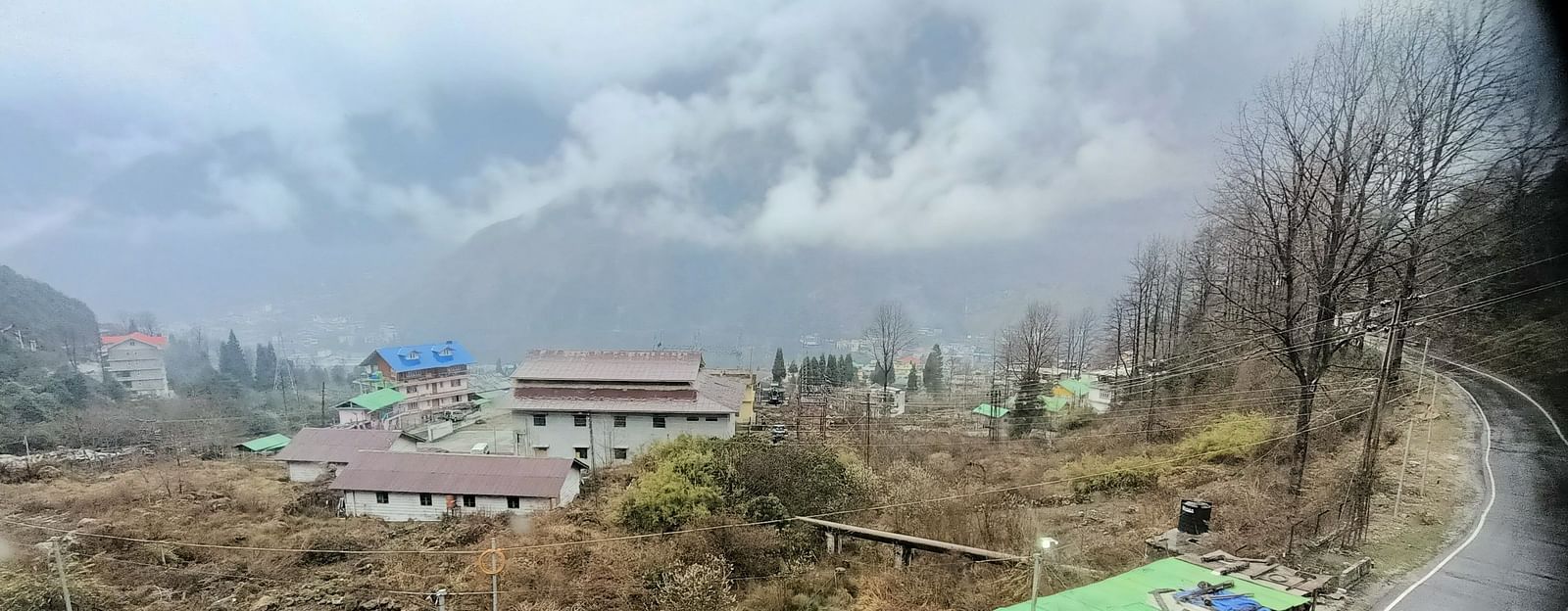 View of buildings and mountains from a balcony of our hotel