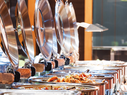A close up shot of many items kept on trays during a Buffet - La Maison Hotel, Doha