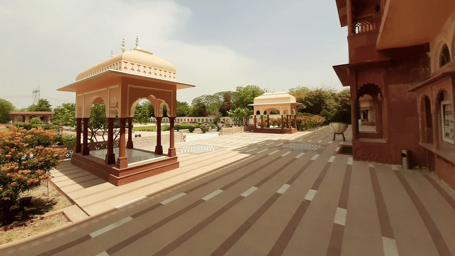 Heritage courtyard and pavilion architecture at Umaid Palace with landscaped gardens.