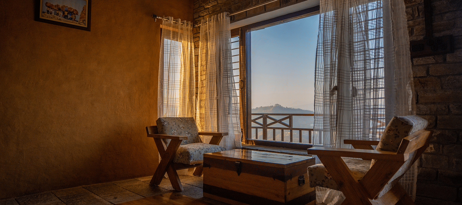 A cosy wooden room with panoramic windows, bathed in soft morning light, offering stunning views of the valley. - Blusalzz Homes The Himalayan Bungalow, Almora
