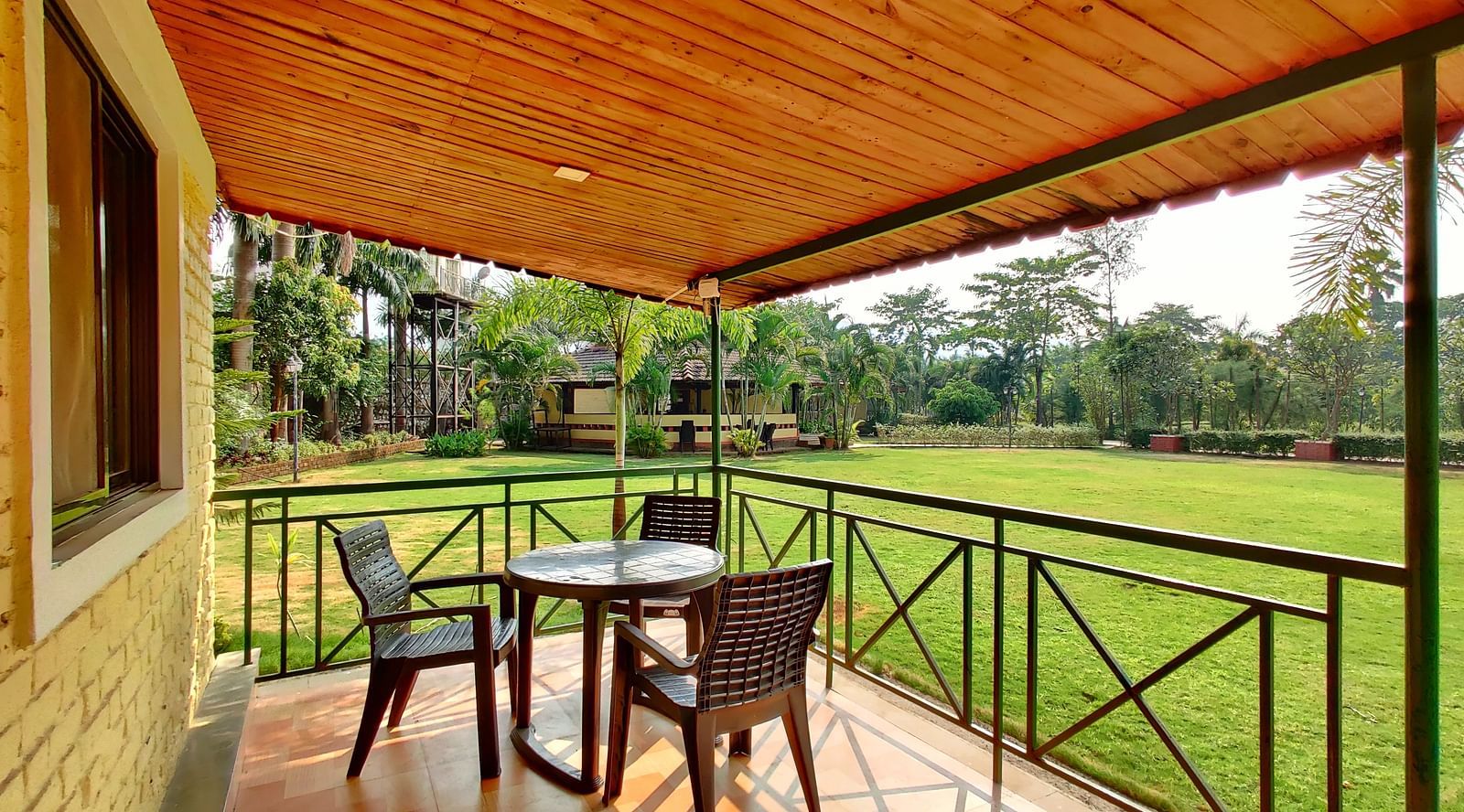 A view of a balcony overlooking a grassy lawn at The Kanila Resort.