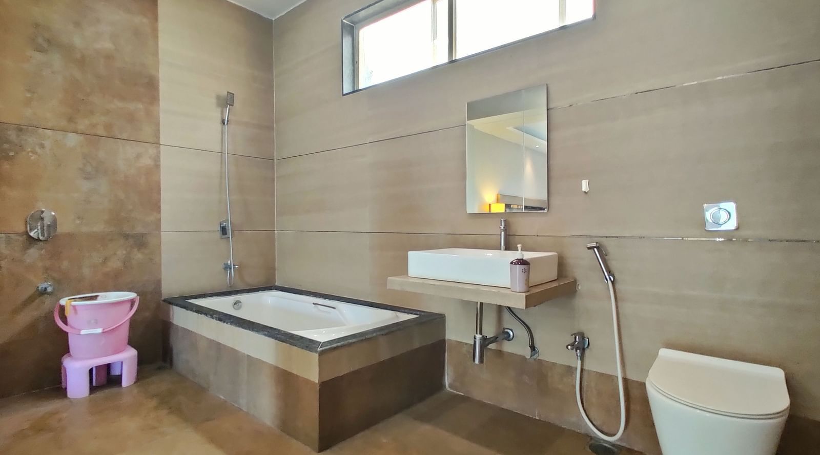 Bathroom of Super Premium Room at The Kanila  Resort  featuring a bathtub in the corner along with a toilet.