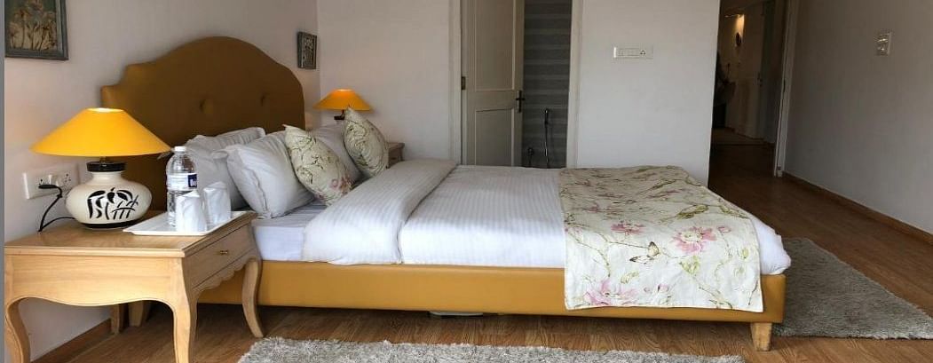 Standard Room with comfy bed and bed table at Pinewood, Nainital