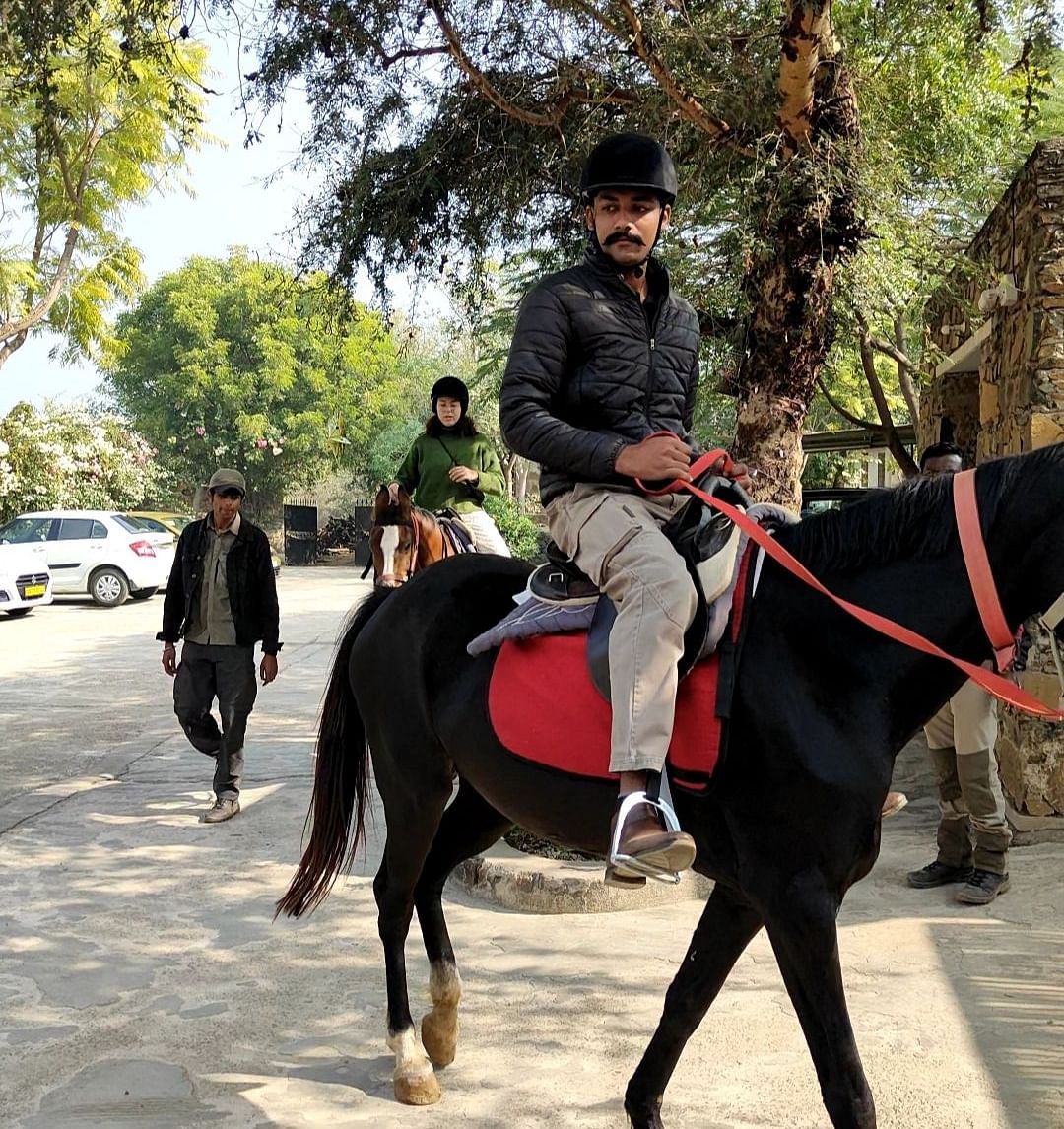 An image of a man riding a horse - Utsav Camp Sariska