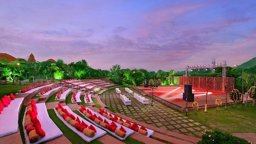An overview of rangbhoomi amphitheatre with seating arrangements, lighting and speakers - The Ananta Udaipur