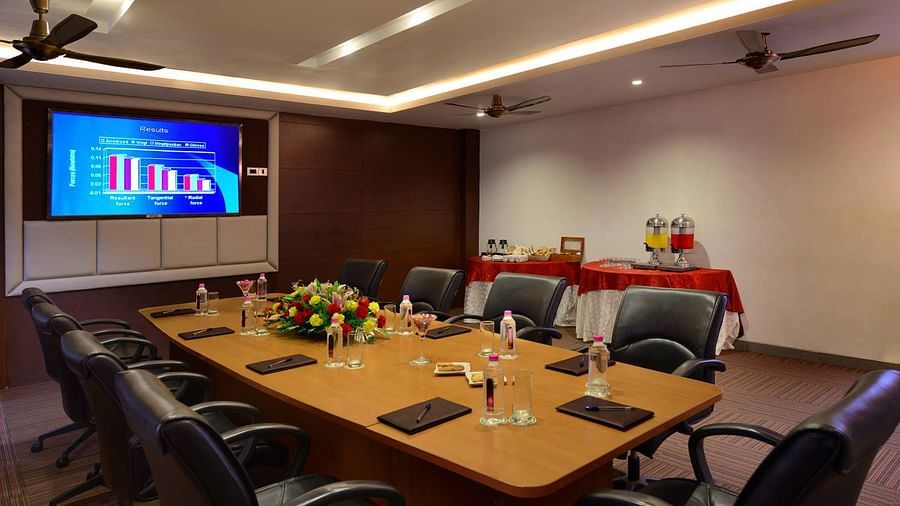 A view of the board room with a tv, chairs and a big desk - Ananta udaipur