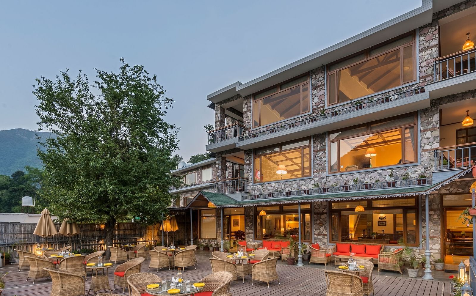 Outdoor restaurant at Fishermen's Lodge, Bhimtal, featuring a beautiful view, creating a perfect setting for dining in nature.