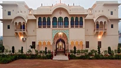A facade image of Dula Garh during a evening