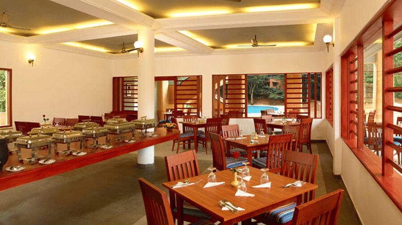 An overview of the seating arrangement inside Peppermint the in-house restaurant - Abad Green Forest, Thekkady - A Forest Resort in Kerala.