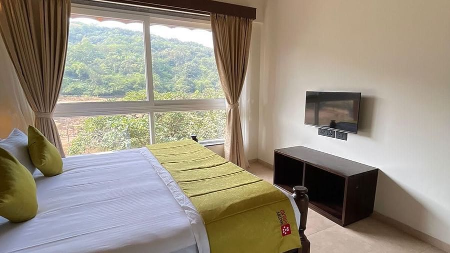 bedroom with forest view and bed