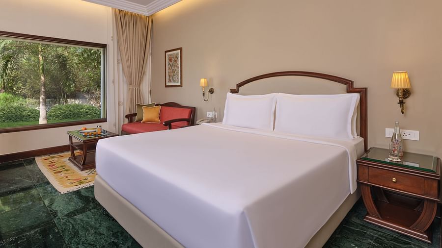The Premium King Garden View Room at The Ummed Ahmedabad features a plush king size bed, elegant decor, and a scenic garden view