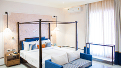 Bright bedroom showcasing the bed and natural light.