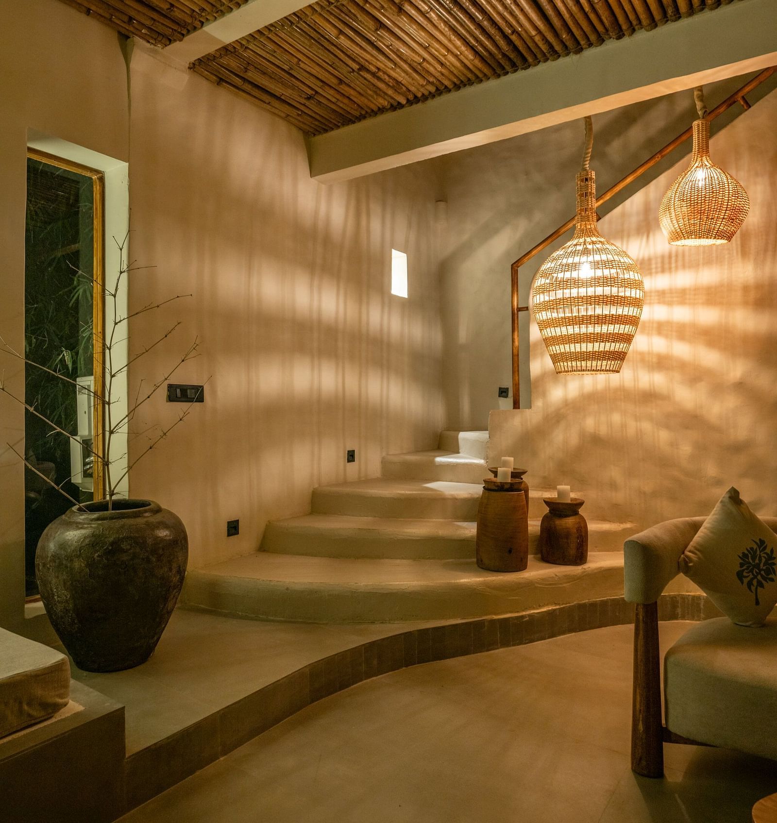 Spacious living room , woven pendant lights, and earthy decor.
