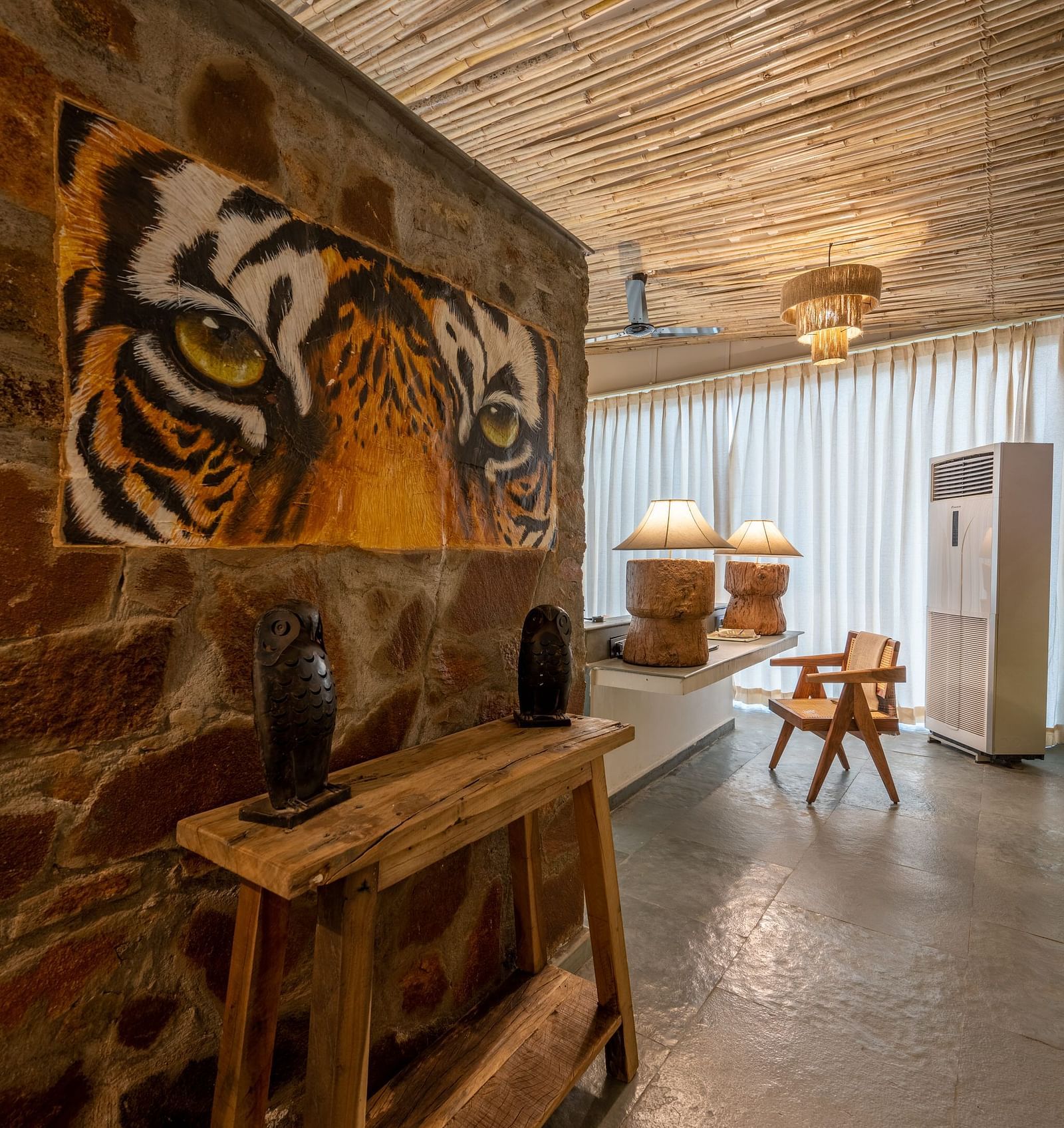 An image of a room with decorative lighting and wall paintings - Utsav Camp Sariska