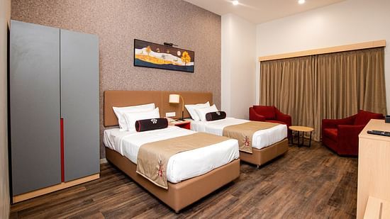 full view of premier rooms with twin beds and posh interiors for a relaxing stay - Mastiff Hotel, Ankleshwar