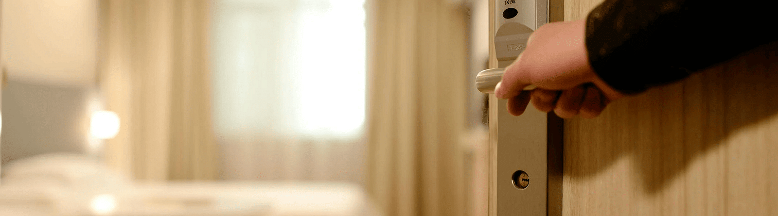image of a person opening the door to a room