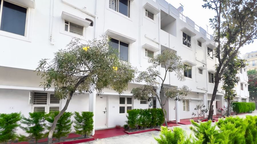 Exterior view of apartment building with greenery at The Pinnacle, Electronic City.