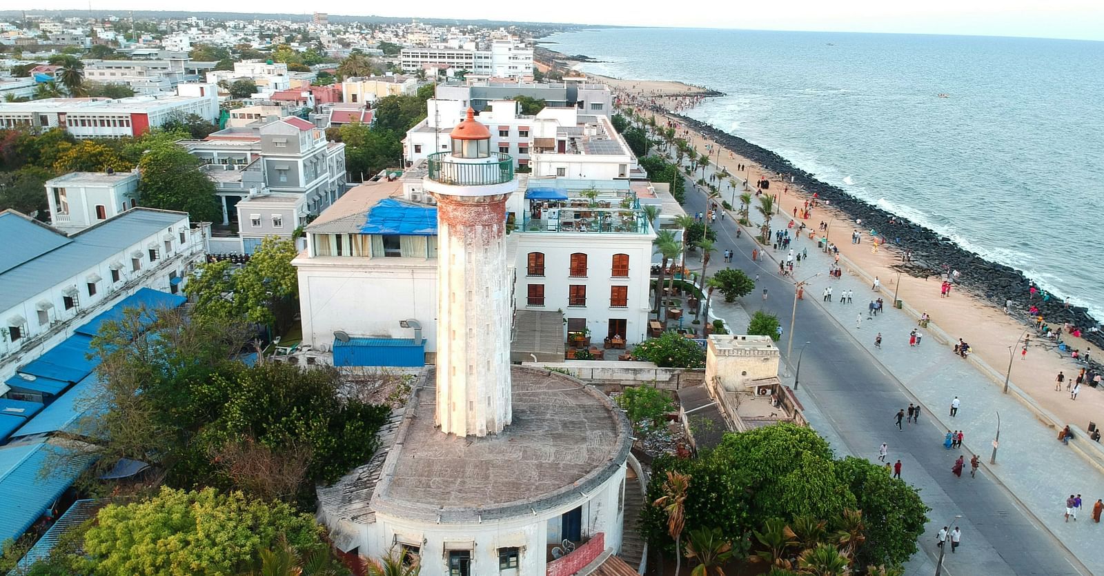 An overview of pondicherry with a lighthouse in view and the beach next to it