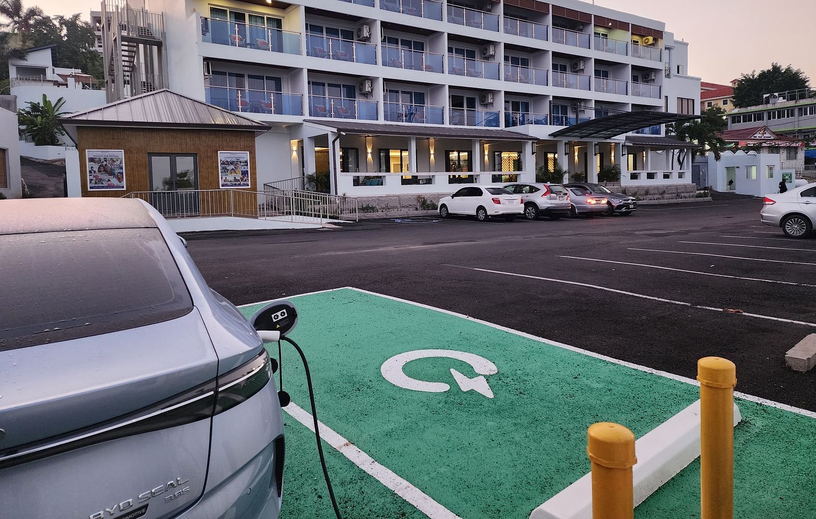 A hotel exterior with an electric car charging station in the parking lot - Hotel 39, Jamaica