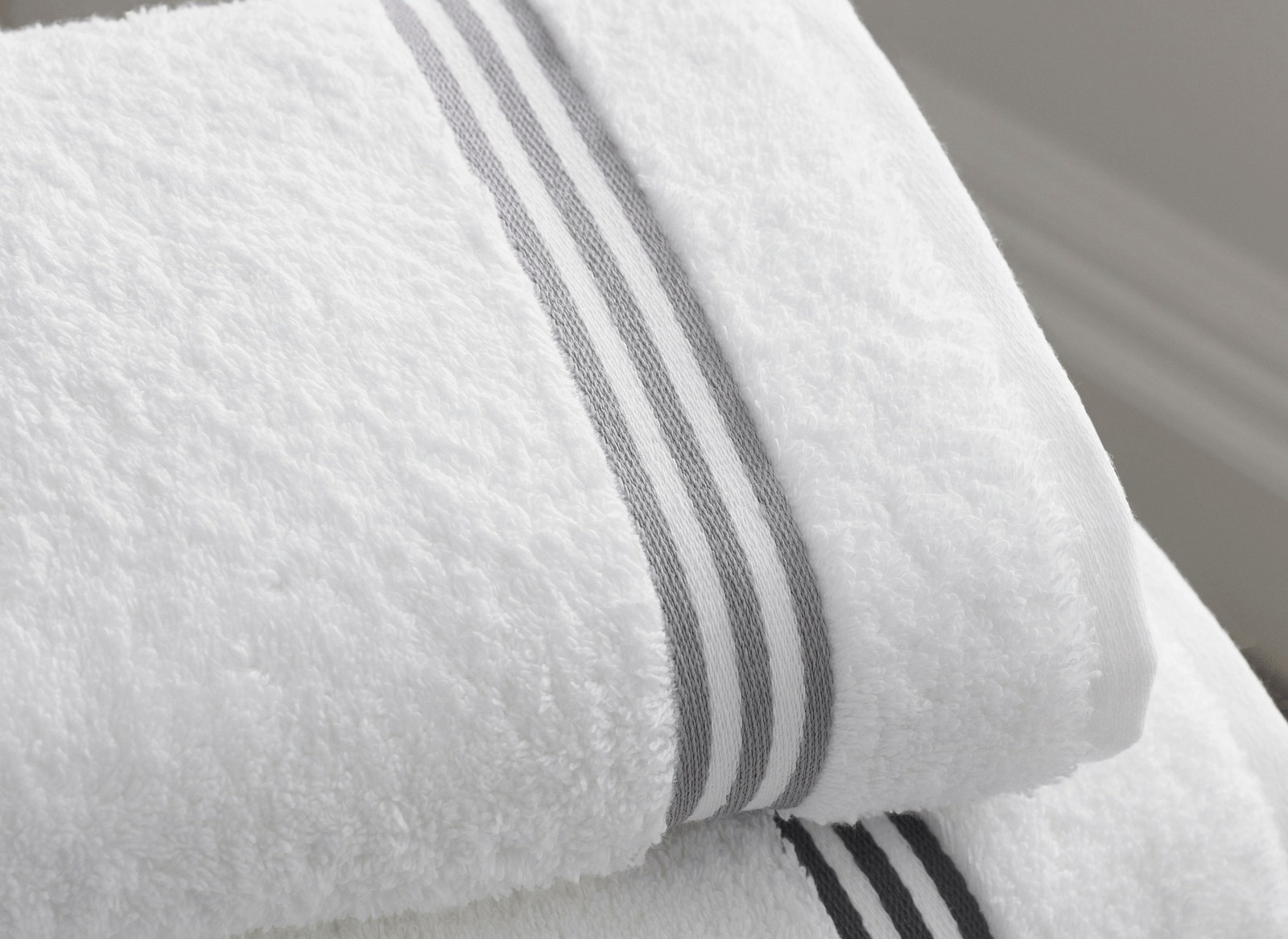 Close up of a folded towel placed on top of another.